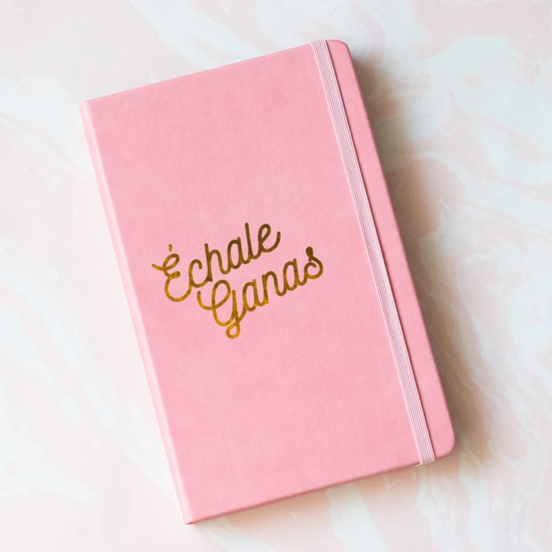 pink notebook with phrase échale ganas