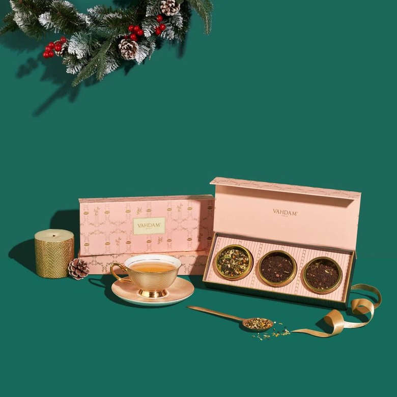 Vahdam tea set with pink boxes surrounded by tea spoon and cup
