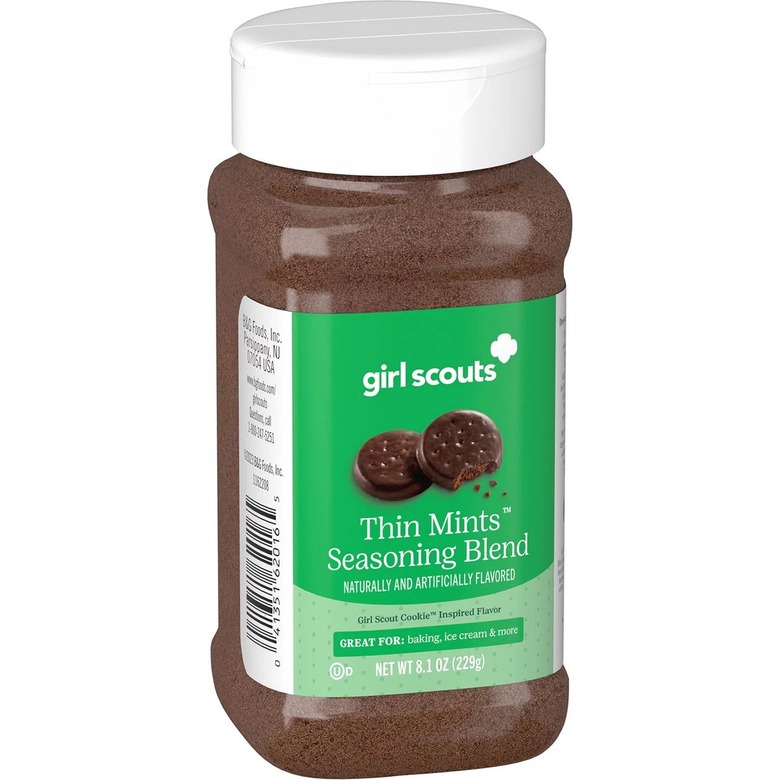 A clear plastic spice container filled with Girl Scouts Thin Mints Seasoning Blend. It has a bright green label.