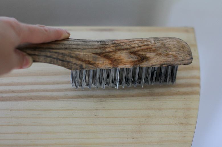 Scrubbing raw wood with wire brush