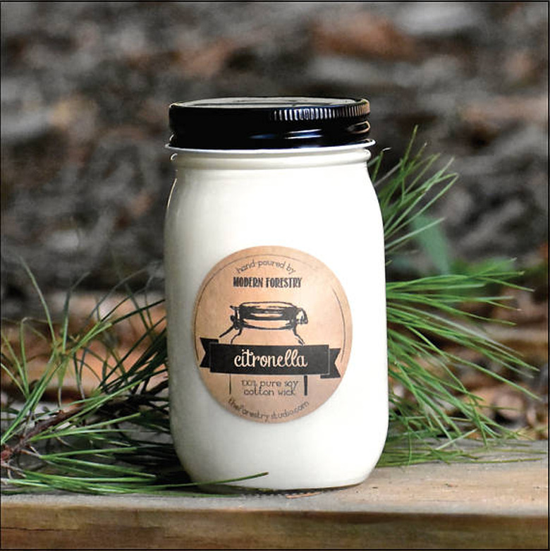 A black-and-cream mason jar with a citronella candle label.