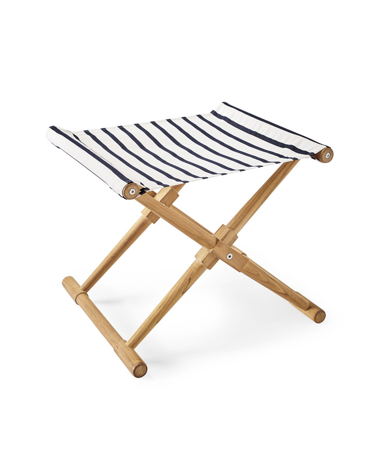 A teak-legged camp stool with a striped blue-and-white seat.