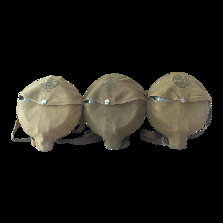 Three mess kits in canvas pouches.