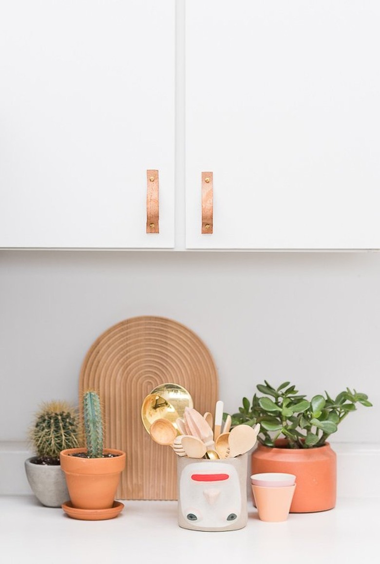 white kitchen with leather pulls