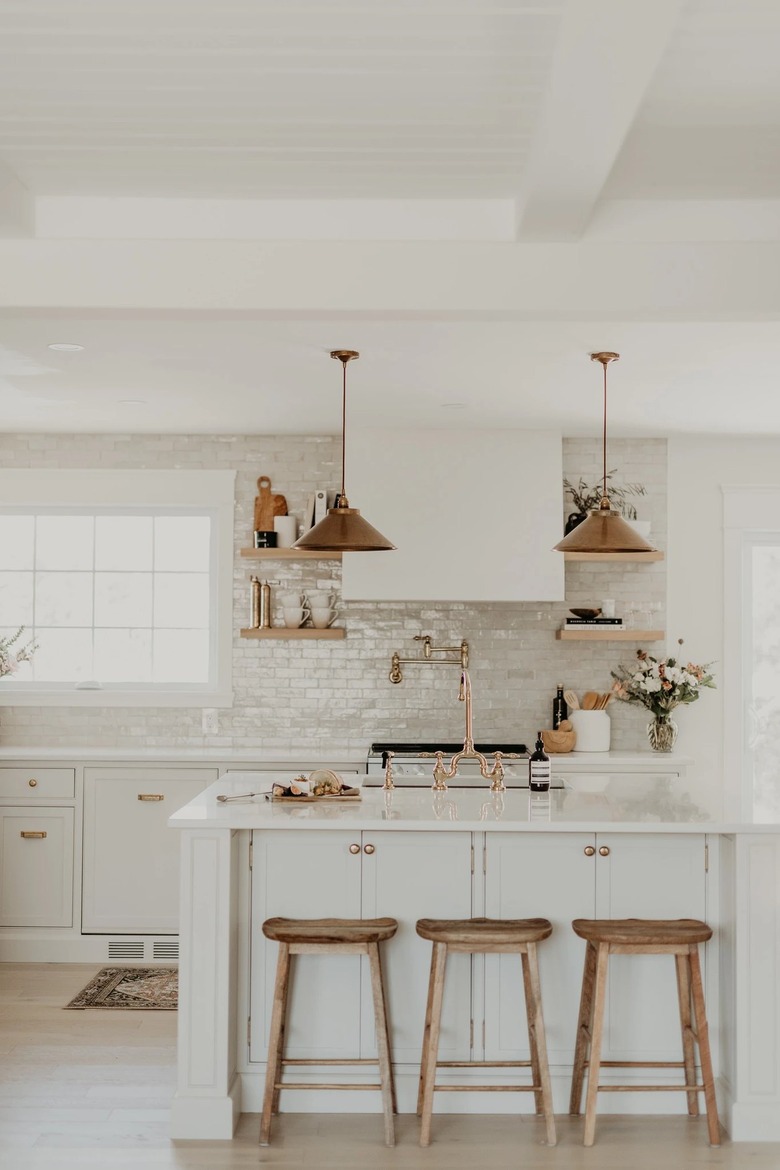 white kitchen with brass hardware