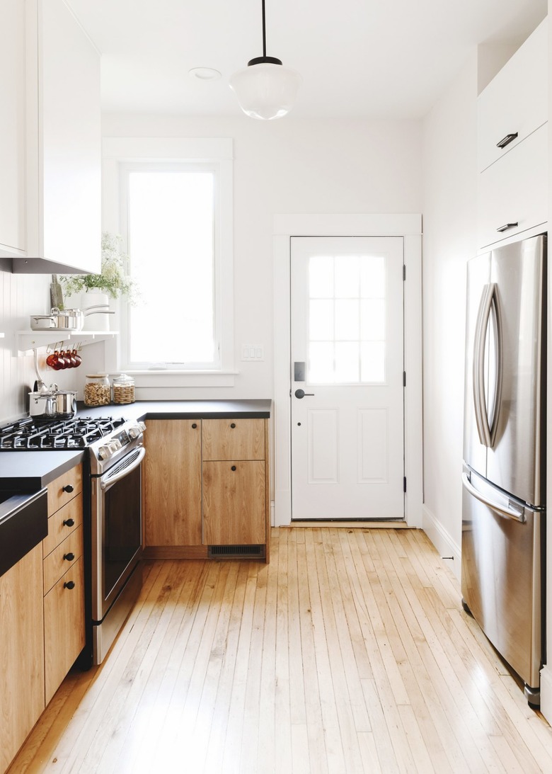 white and wood finish kitchen with black knobs