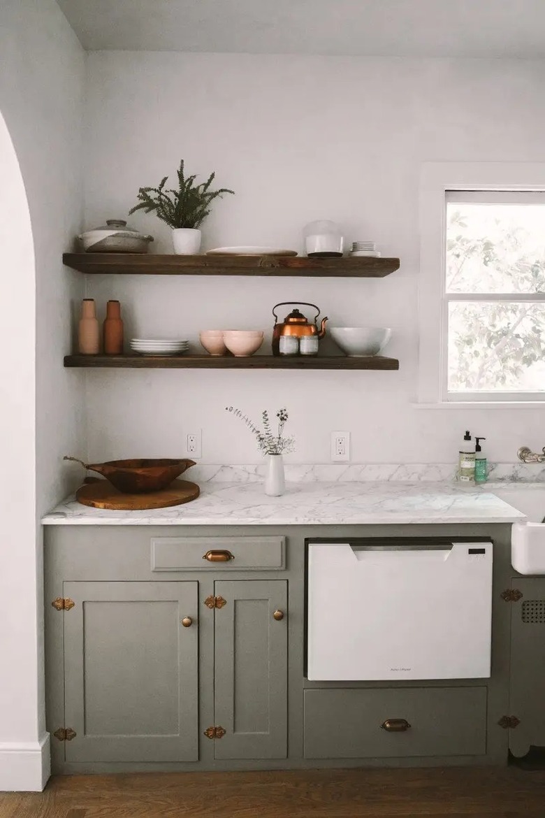 sage green kitchen with brass hardware
