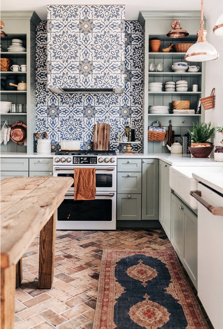 sage green kitchen with painted gray knobs