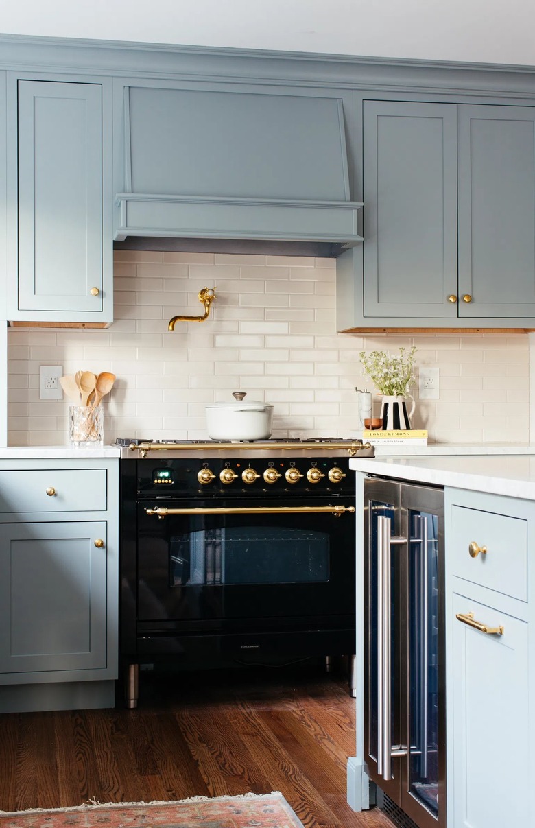 blue kitchen with gold hardware
