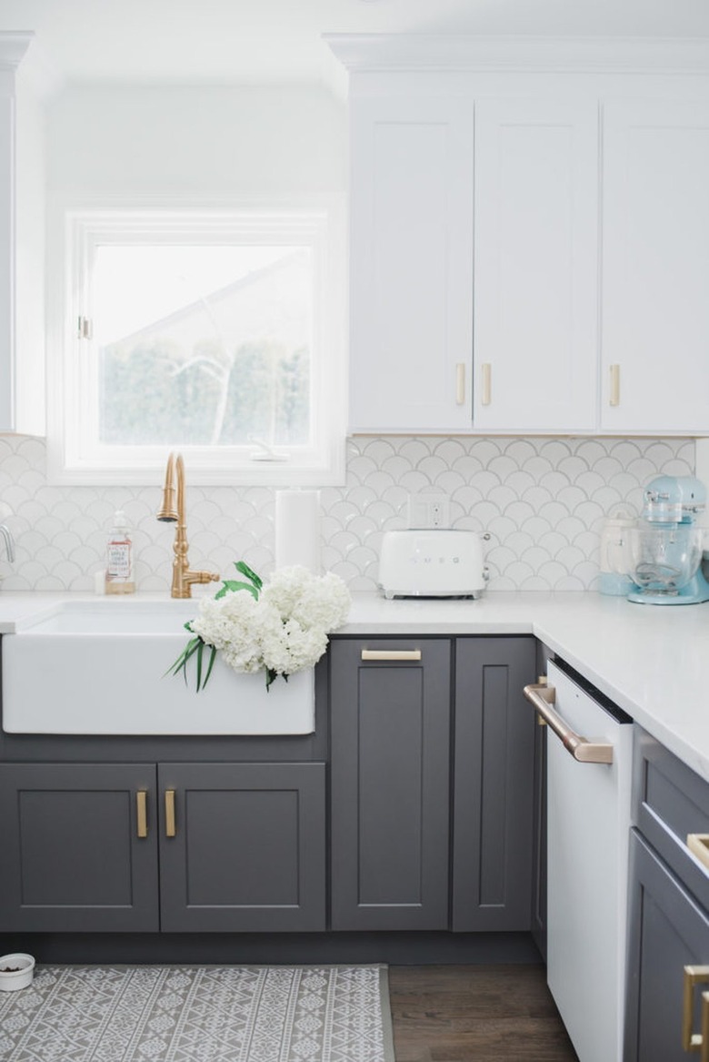 white and gray kitchen with brass hardware