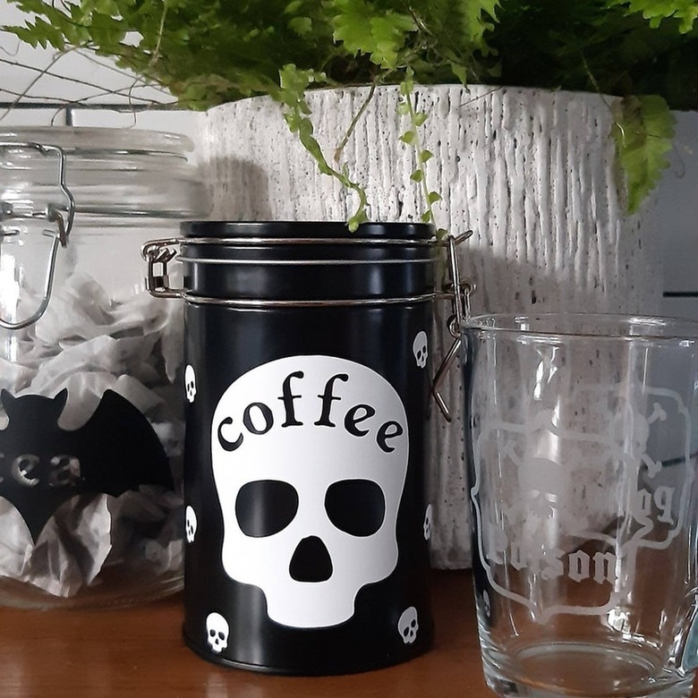 black storage container with white skull label reading coffee