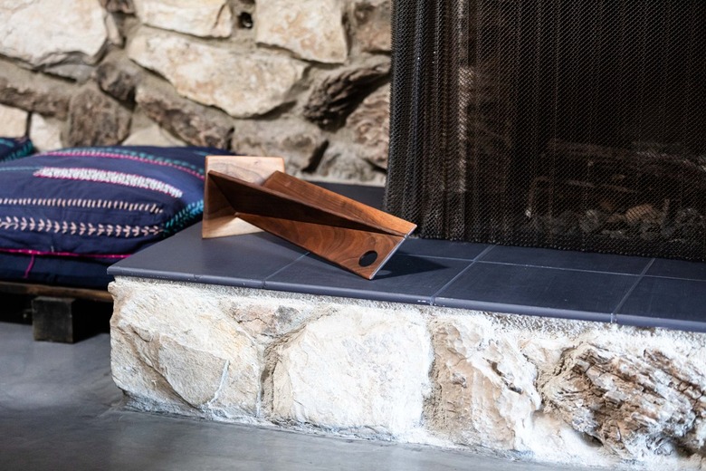 Rock fireplace with charcoal gray tile for hearth