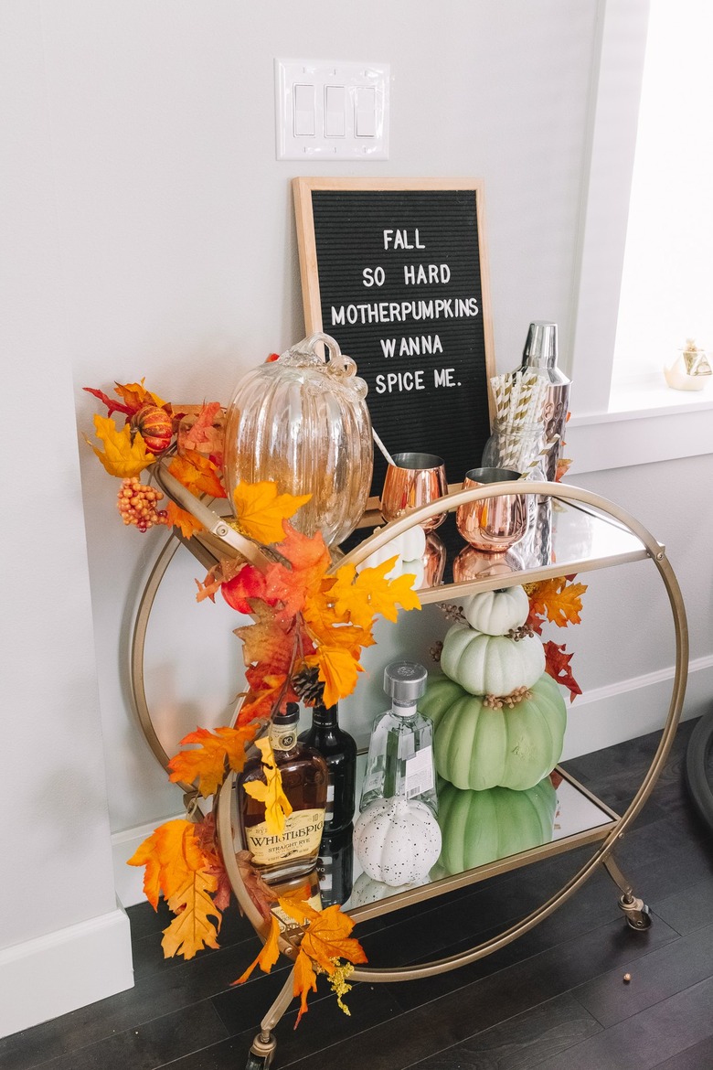 Bar cart with pumpkins.