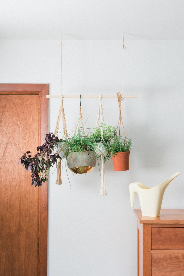 Hanging plants with wood door and dresser with watering can