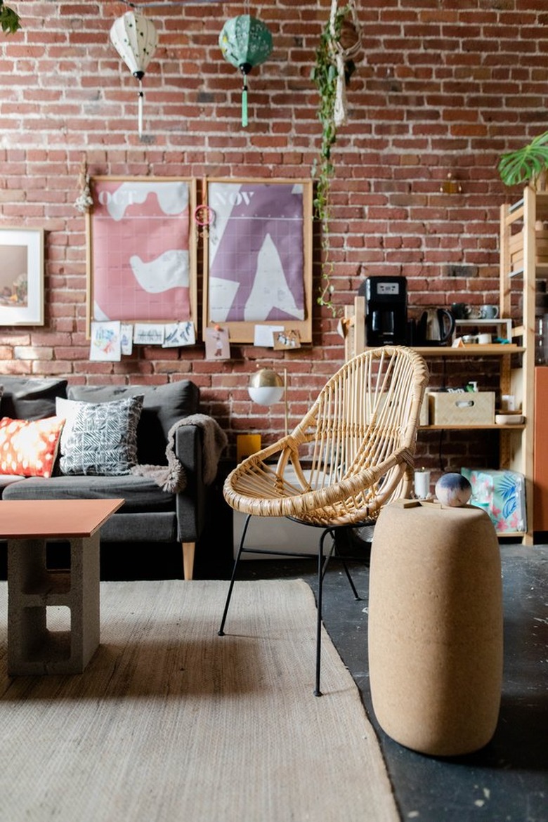 Living room with brick wall and boho decor.