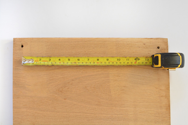 Piece of wood with a tape measure extended to mesure the length