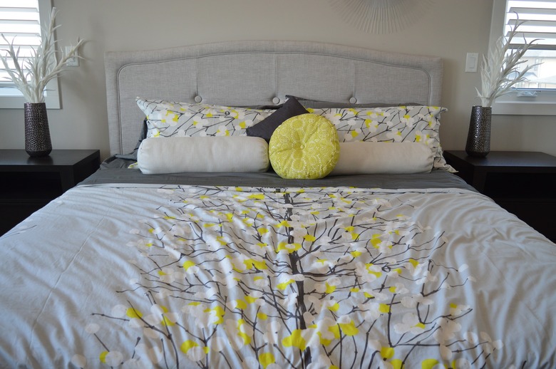 Bed made with colorful duvet and pillows
