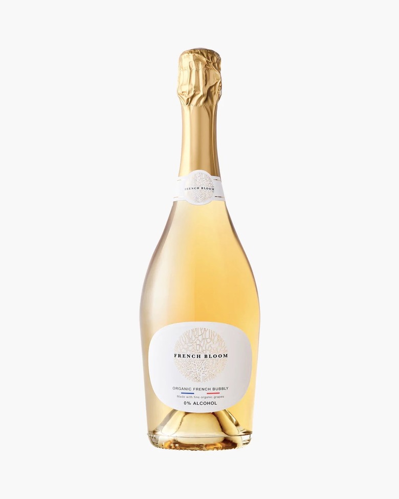 A bottle of French Bloom's organic French bubbly in a clear bottle with gold wrapping at the top.