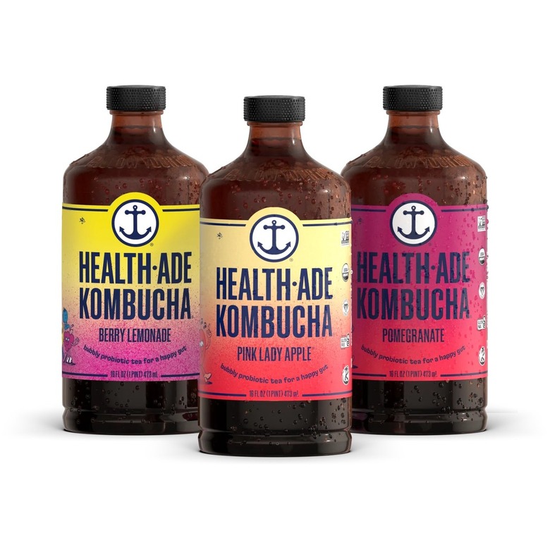 Three Health-Ade kombucha bottles in the pink lady apple