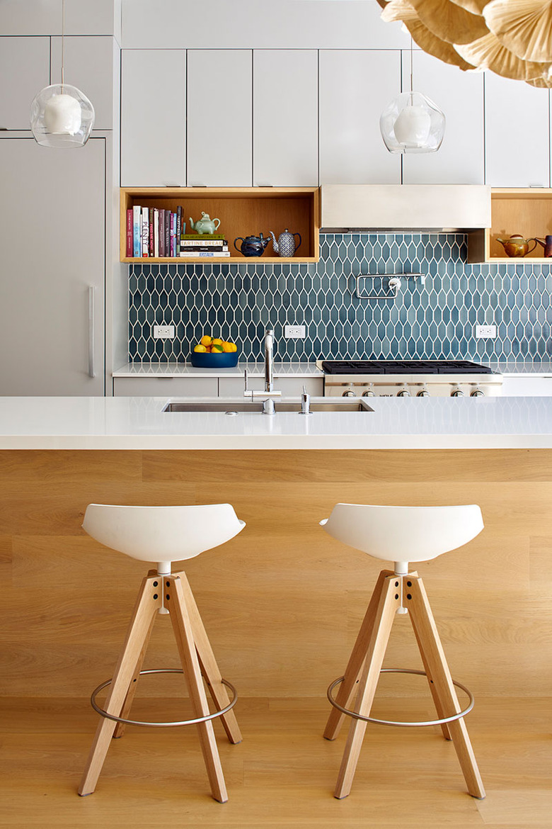 midcentury modern kitchen backsplash idea with blue tile and white cabinets
