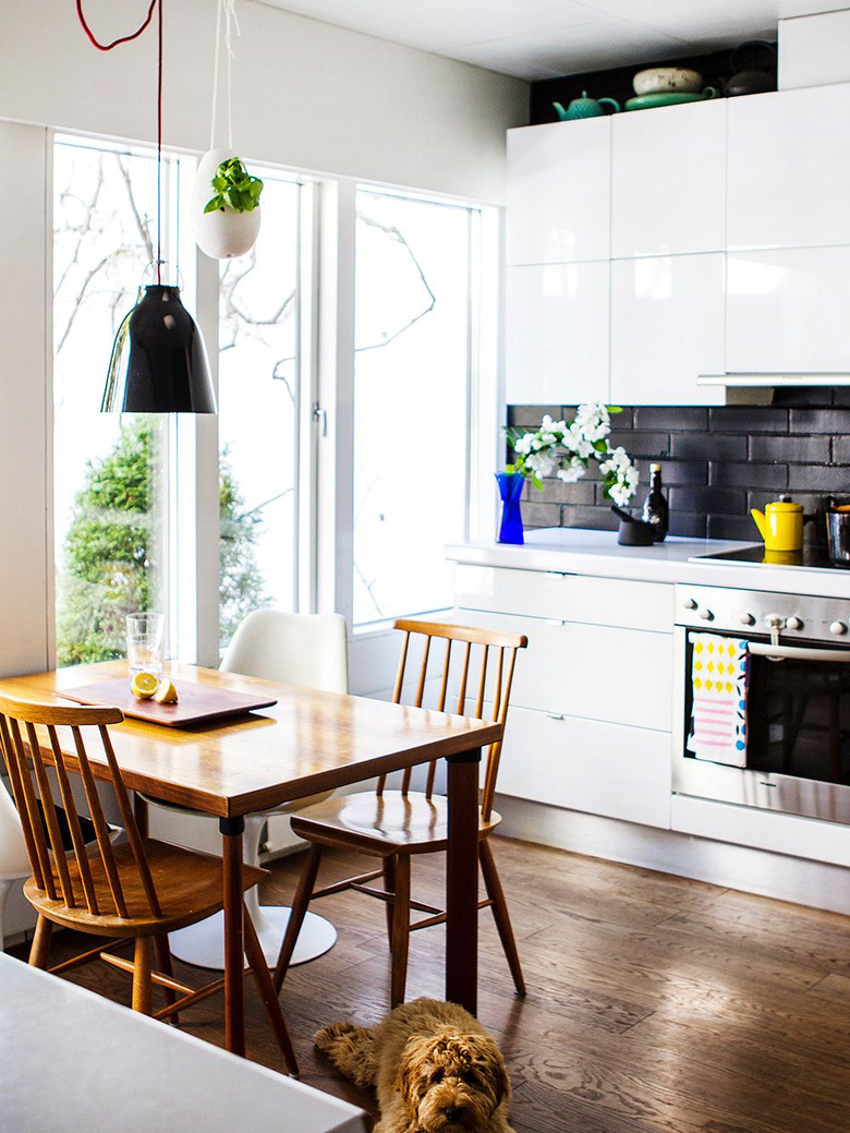 hardwood kitchen flooring with white cabinets and white countertop