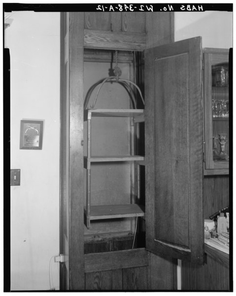 a first floor built-in dumbwaiter featuring three shelves