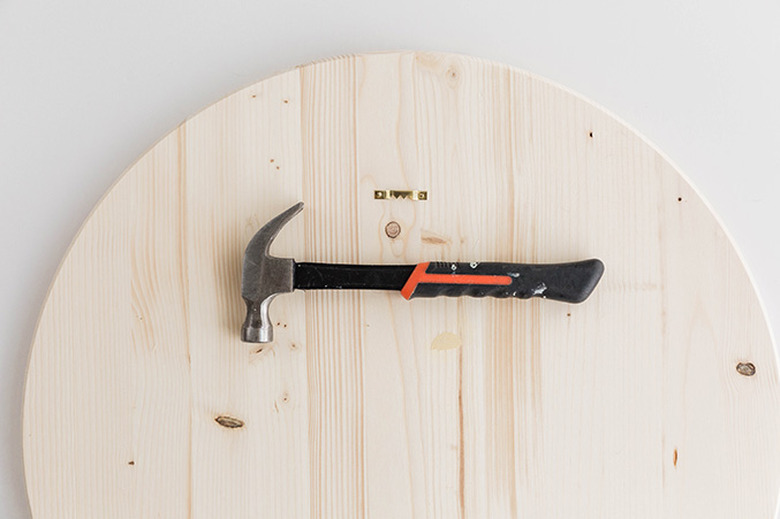 Add the hanging hardware to the back top center of the wooden circle.