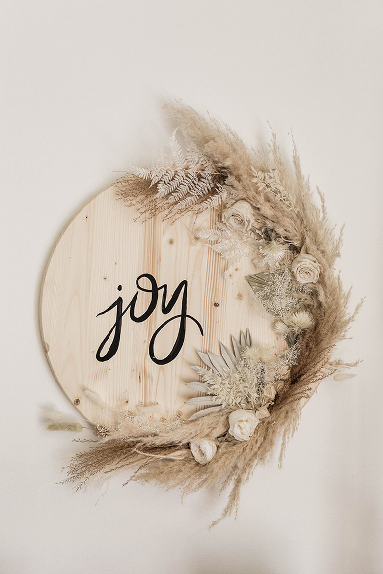 Wood sign with dried flowers and Joy