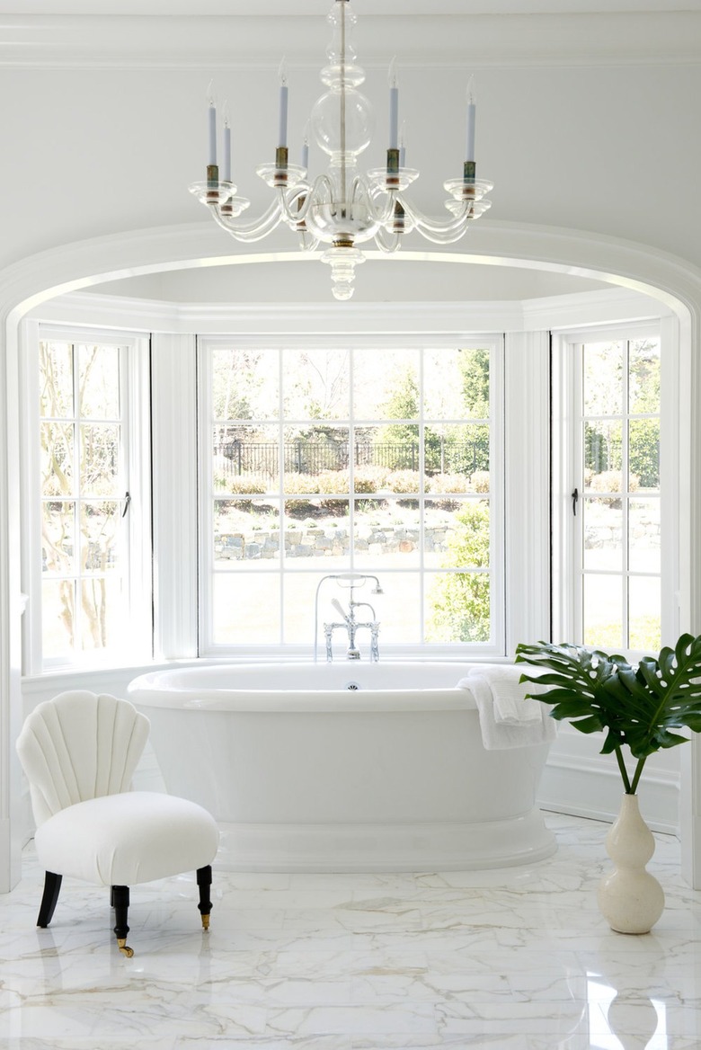All white Palm Beach Regency bathroom with art deco shell chair