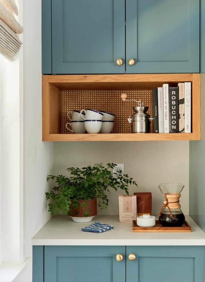 Teal kitchen cabinets with coffee station.