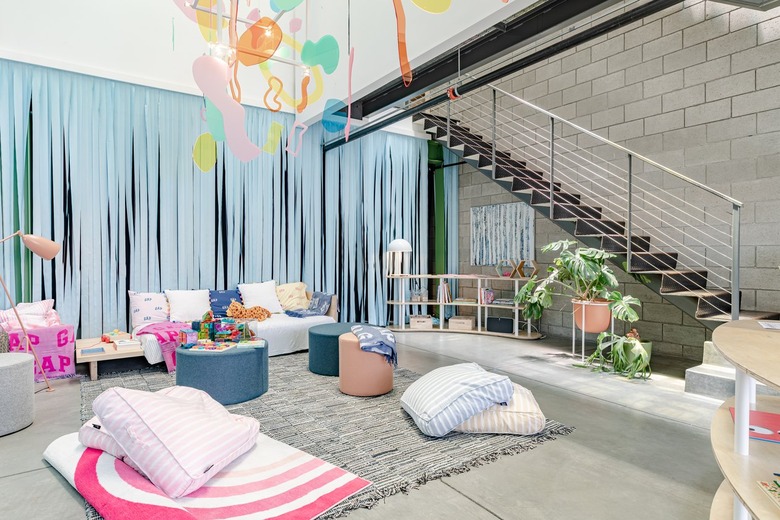Hunker living room staged with pink and blue throw pillows