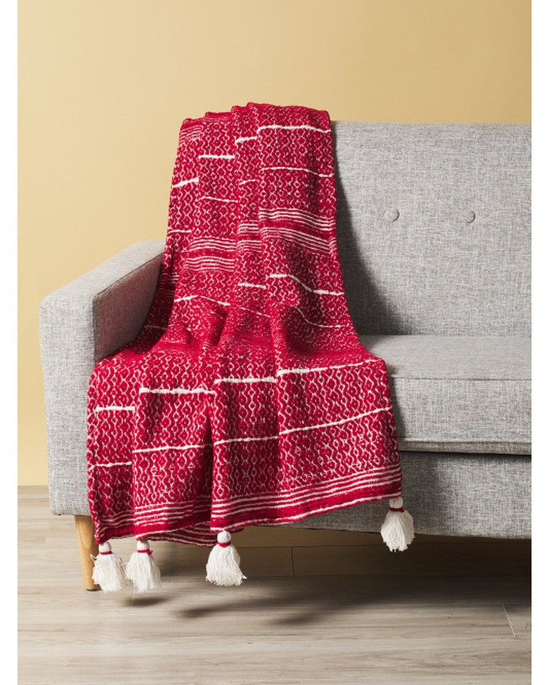 red and white throw blanket with tassels