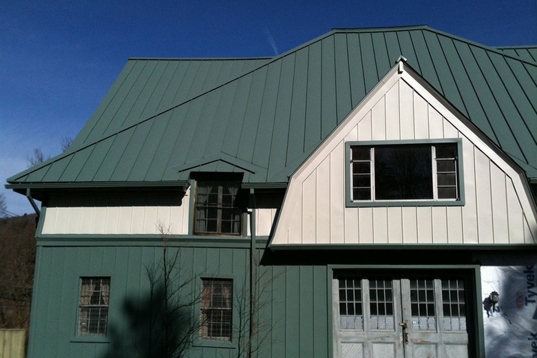 house with green roof and green and white exterior walls