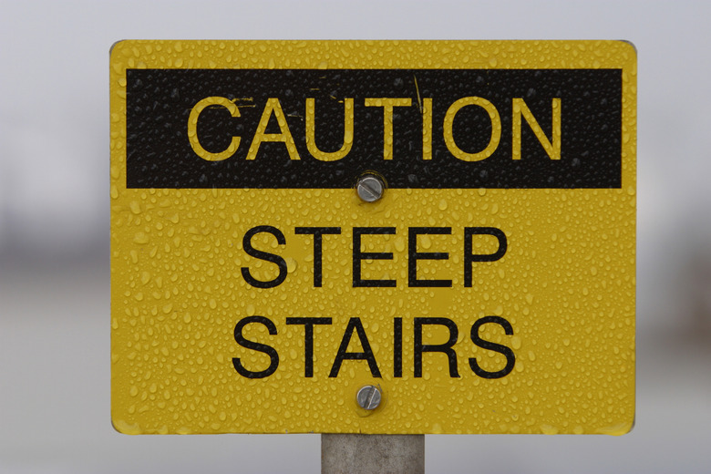 Scratched steep stairs warning sign