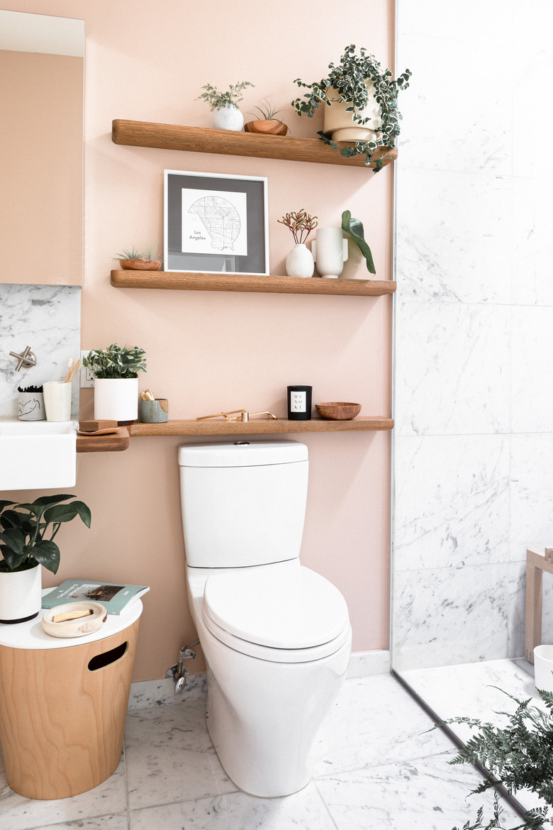 toilet with light pink wall