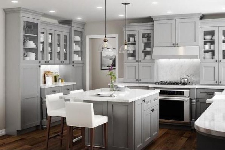 How to Install Crown Molding on Cabinets in kitchen with gray cabinets and dark wood floor