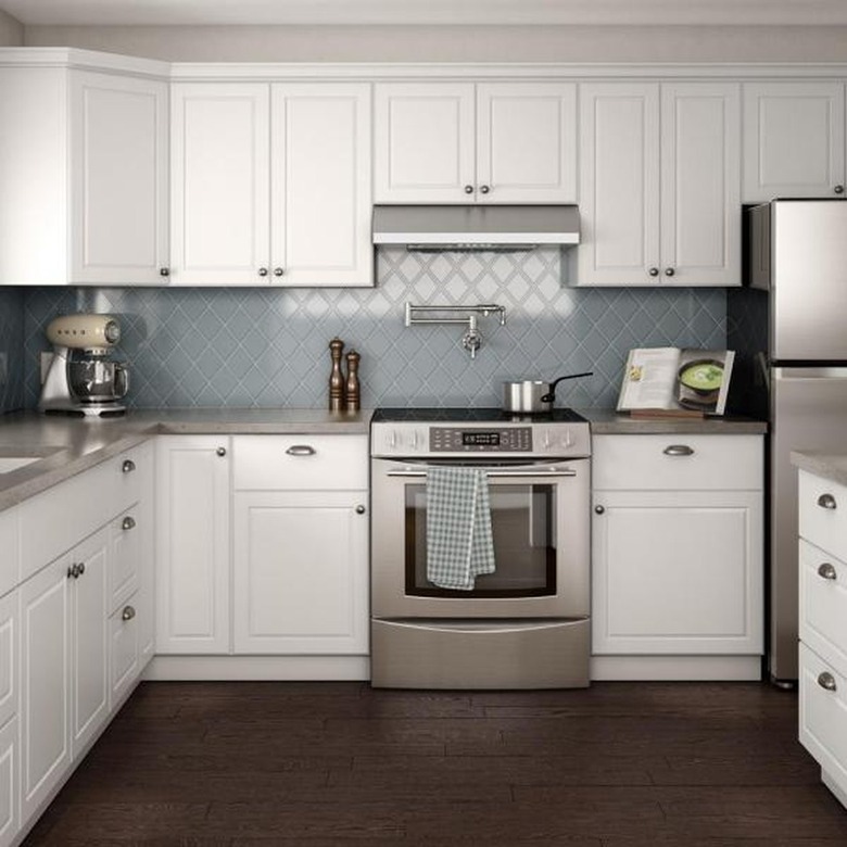 How to Install Crown Molding on Cabinets in kitchen with blue tile backsplash and wood floor