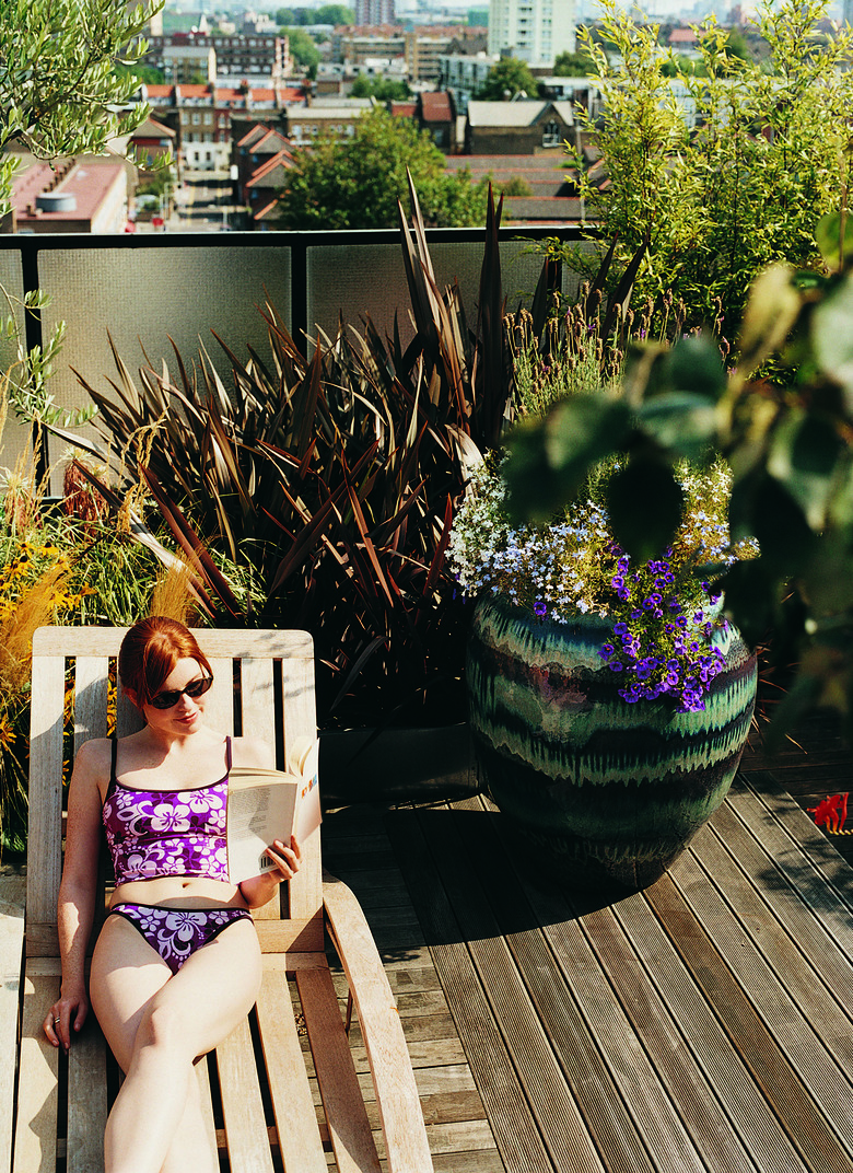 Woman Sunbathing in Her Roof Garden