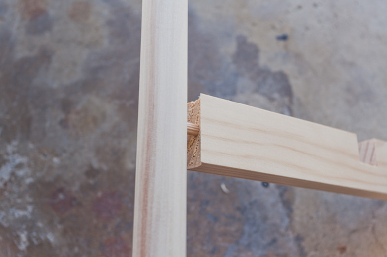 Inserting a dowel into the cross brace