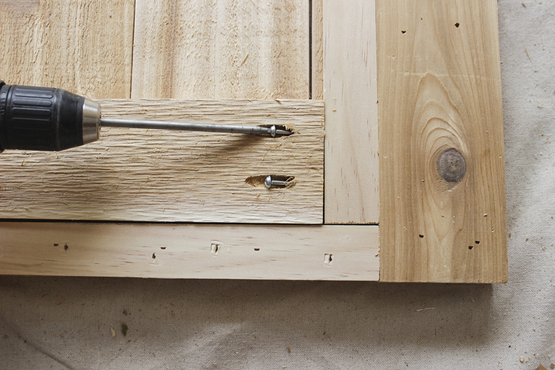 Screwing the bottom of the leg frame together.