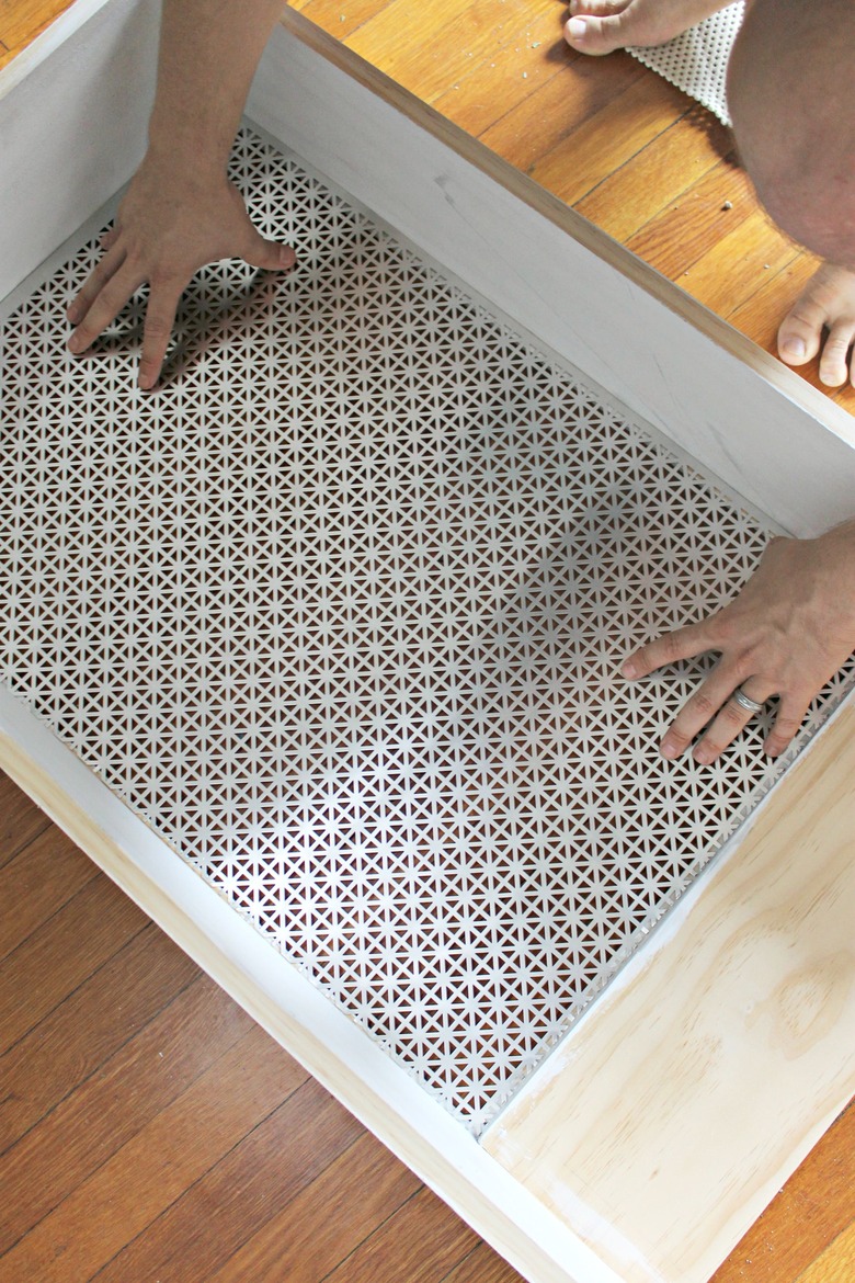 place cut tin into radiator cover frame