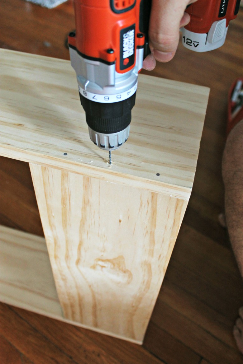 nailing the base board in place