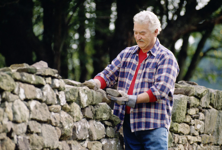 Man building rock fence