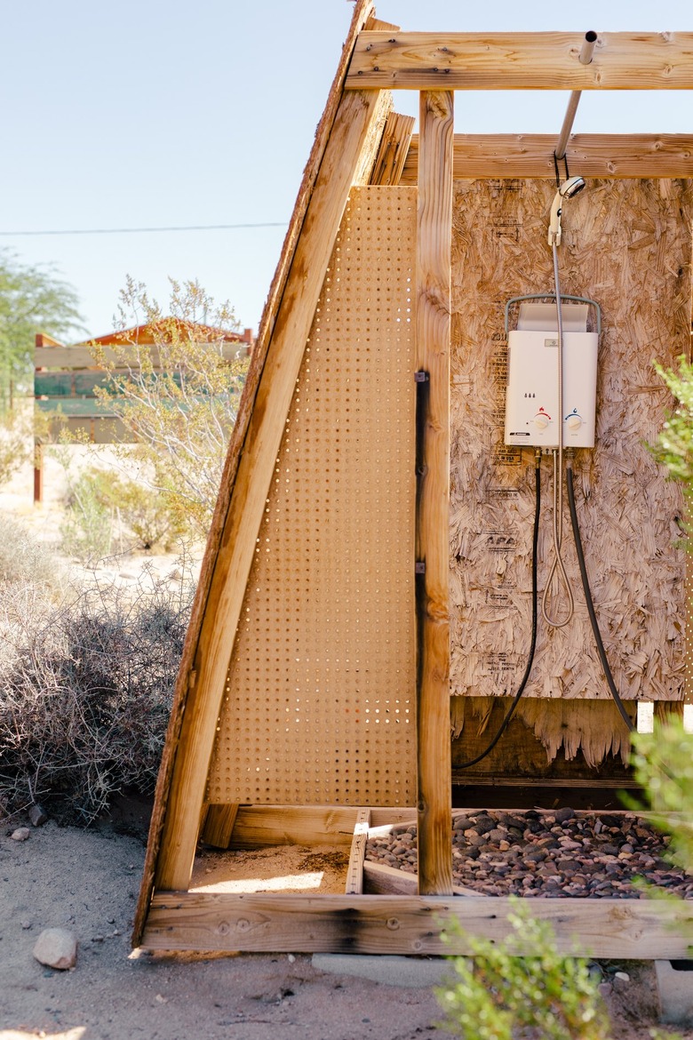 an outdoor shower structure made of plywood
