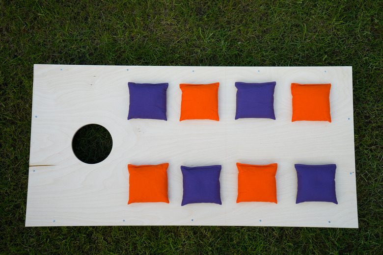 Cornhole Board Flat Lay with beanbags on grass