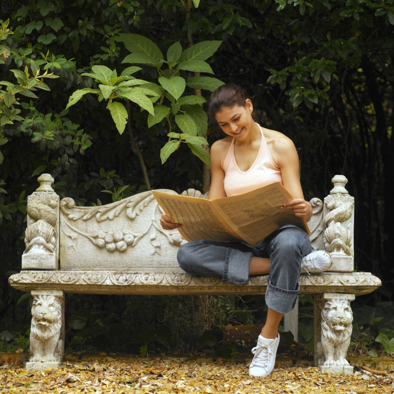 Front view of young woman sitting on bench