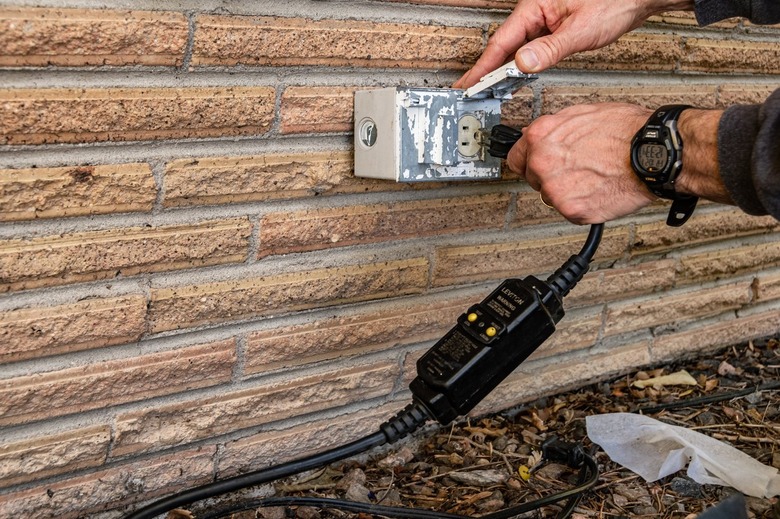 outdoor electrical outlet on brick wall