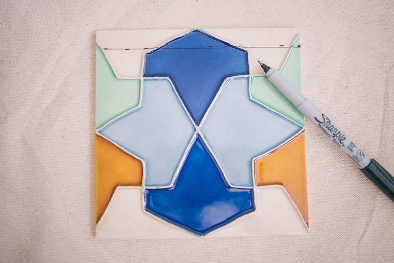 Cut line drawn on ceramic tile with marker