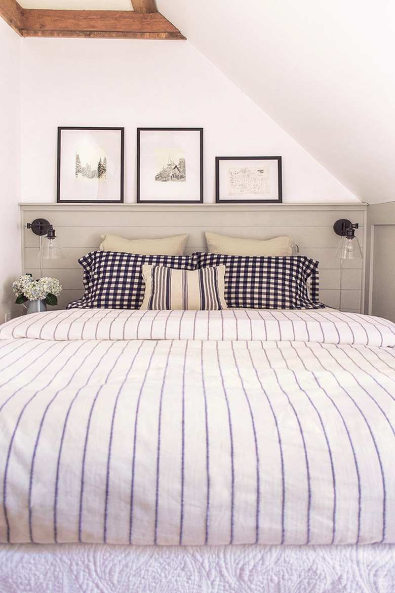 mini gallery wall in bedroom with slanted walls