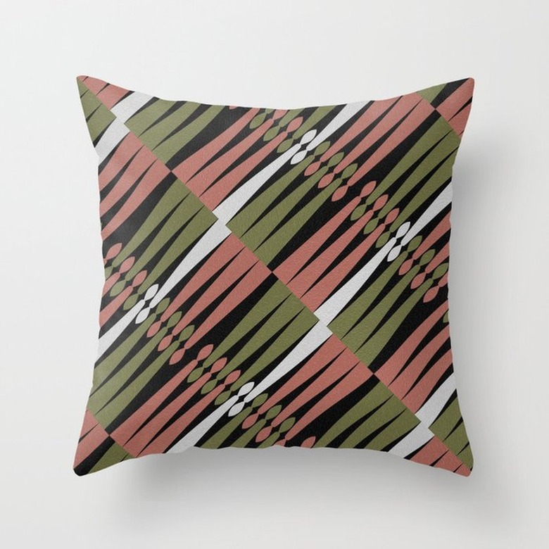 A Kwanzaa-inspired throw pillow featuring candle-like red